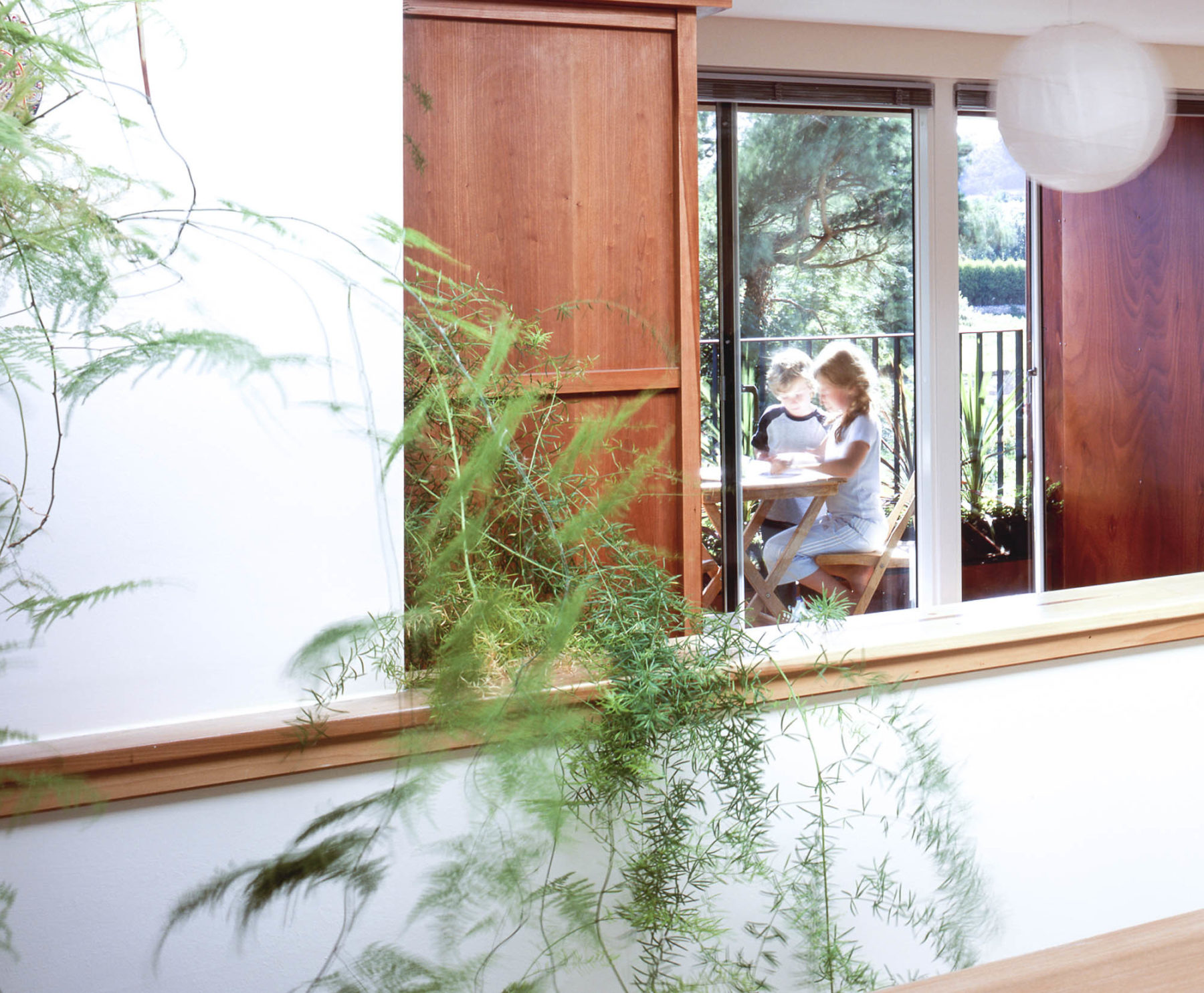 Interior of family home at Princes Gate, looking through to balcony from stairwell. By Malcolm Fraser Architects